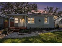 Charming home featuring stone walkway, covered porch, and manicured landscaping in a residential neighborhood at 306 W Alva St, Tampa, FL 33603