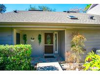 Inviting front entrance with decorative door, stone walkway, and well-maintained landscaping at 707 Old Mill Pond Rd, Palm Harbor, FL 34683