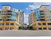 Condos with yellow exteriors, blue glass, and multiple balconies, showcasing city living at its finest at 1120 E Kennedy Blvd # 1126, Tampa, FL 33602