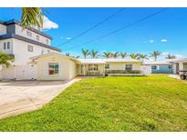 Charming single Gathering home with a well manicured lawn and metal roof at 7984 1St S Ave, St Petersburg, FL 33707