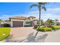 Stunning Mediterranean style home featuring a paver driveway, lush landscaping, and a two-car garage at 2028 Illinois Ne Ave, St Petersburg, FL 33703