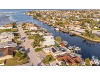 Waterfront property showcasing a private pool and boat dock with gulf access in a canal community at 3939 Rudder Way, New Port Richey, FL 34652