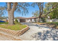 Charming single-story home with a well-maintained yard, mature trees, and a cozy front porch at 5202 Cumberland Dr, Tampa, FL 33617