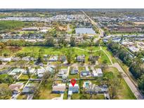 An aerial view showing the neighborhood, nearby pond, and the home's location in relation to the surrounding area at 130 81St Ne Ave, St Petersburg, FL 33701
