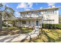 Charming two-story home with a well-manicured lawn, inviting entrance, and light blue shutters at 11124 Corlett Rd, Riverview, FL 33578