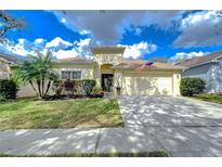 Charming one-story home featuring a well-manicured lawn, lush landscaping, and a two-car garage at 1168 Emerald Hill Way, Valrico, FL 33594