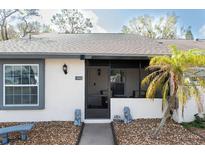 Charming single-story home features a screened porch and decorative lion statues at the entrance at 3942 La Costa Ln, Largo, FL 33771