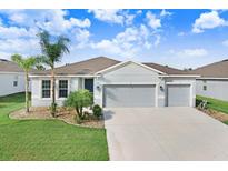 Charming single-story home with well-manicured lawn and a spacious three-car garage at 6307 113Th E Ter, Parrish, FL 34219