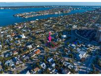 Bird's eye view of a quaint neighborhood near the water with mature trees and charming homes at 939 Mandalay Ave, Clearwater Beach, FL 33767