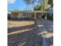 Charming one-story home featuring a welcoming front porch and brick-paved driveway at 115 11Th Ave, Indian Rocks Beach, FL 33785