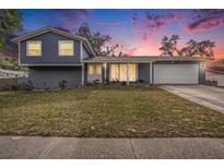 Charming two-story home featuring a well-maintained lawn and inviting facade against a colorful twilight sky at 8019 Capwood Ave, Temple Terrace, FL 33637