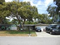 Charming single-story home featuring a mature tree and well-maintained lawn at 1372 S Hillcrest Ave, Clearwater, FL 33756