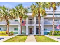 Inviting condo building featuring well-maintained landscaping and charming architectural details at 2298 Americus E Blvd # 6, Clearwater, FL 33763