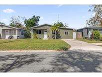 Charming single-story home with a well-maintained lawn, concrete driveway, and a small palm tree in the front yard at 2851 16Th N Ave, St Petersburg, FL 33713