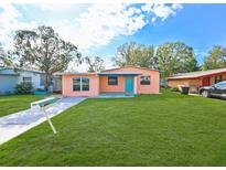 Charming single-story home with a well-manicured lawn and a bright blue front door at 4710 23Rd S Ave, St Petersburg, FL 33711