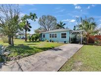 Charming single-story home featuring a well-manicured front yard and a welcoming pergola-covered entrance at 2661 45Th S St, Gulfport, FL 33711