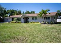 Charming single-story home with a well-manicured lawn and tropical landscaping at 2391 66Th S Ter, St Petersburg, FL 33712