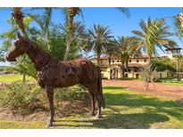 Spanish-style home with courtyard and fountain, surrounded by palm trees at 33642 Blanton Rd, Dade City, FL 33523