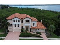 Stunning waterfront home boasts a grand exterior and beautiful landscaping at 109 Wateredge Ct, Safety Harbor, FL 34695