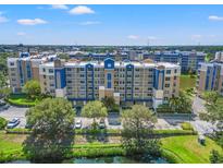 Aerial view of a community of apartment buildings, with a lake and lush landscaping at 960 Starkey Rd # 3406, Largo, FL 33771