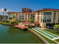 Aerial view of waterfront community with pool, dock, shuffleboard at 105 Island Way # 121, Clearwater Beach, FL 33767