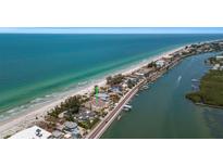 Aerial view of beachfront property with ocean and canal views at 20204 Gulf Blvd # 9, Indian Shores, FL 33785