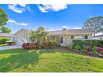 Tan house with nicely landscaped lawn and driveway at 5269 Dover Ne St, St Petersburg, FL 33703