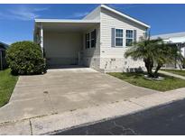 Single-wide manufactured home with carport and landscaped yard at 13225 101St St # 482, Largo, FL 33773