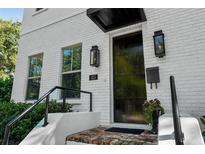 Modern white brick home with black door and stylish light fixtures at 423 21St N Ave, St Petersburg, FL 33704