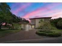 Two-story home with stone accents and a lush landscape at 10073 S Yacht Club Dr, Treasure Island, FL 33706