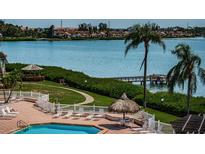 Relaxing pool area with waterfront views and lounge chairs at 6268 Palma Del Mar S Blvd # 406, St Petersburg, FL 33715