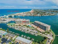 Aerial view of waterfront property with marina, Gulf access, and resort-style amenities at 1 Key Capri # 102E, Treasure Island, FL 33706