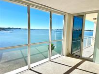 Spacious living room with stunning water views and large windows at 100 Pierce St # 703, Clearwater, FL 33756
