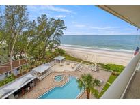 Aerial view of beach resort community featuring pool, beach access, and lush landscaping at 2504 Gulf Blvd # 506, Indian Rocks Beach, FL 33785