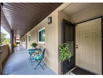 Inviting condo hallway featuring table and chairs with potted flowers, leading to unit #304 at 1245 S Martin Luther King Jr Ave # 304, Clearwater, FL 33756