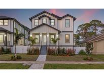 Two-story home with white siding, gray accents, and a landscaped front yard at 125 48Th N Ave, St Petersburg, FL 33703