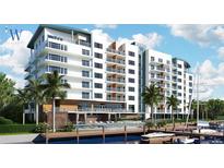 Luxury waterfront resort building with balconies, pool, and boat slips at 411 E Shore Drive # 306, Clearwater Beach, FL 33767