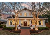 Charming home with a covered porch, manicured landscaping, and warm exterior lighting at 546 18Th Ne Ave, St Petersburg, FL 33704