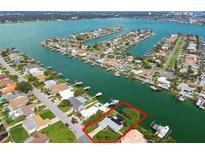 Aerial view of waterfront home with private dock and boat lift at 11600 7Th E St, Treasure Island, FL 33706