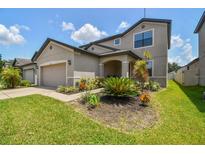 Charming two-story home with a lush landscaped yard and attached two-car garage for added convenience at 12235 Creek Preserve Dr, Riverview, FL 33579