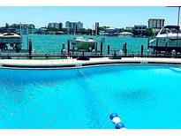 Inviting community pool with waterline and waterfront views at 660 Island Way # 401, Clearwater, FL 33767