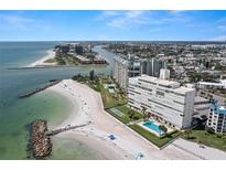 An aerial view of the condominium with beach access and a community pool at 7000 Beach Plz # 505, St Pete Beach, FL 33706