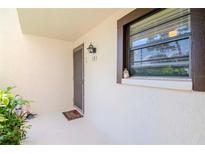 Inviting condo entry with a door and a welcoming mat at 2400 Winding Creek Blvd # 25-101, Clearwater, FL 33761