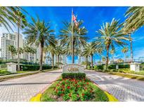 Beautiful entrance to the Grande community with mature palm trees and manicured landscaping at 1170 Gulf Blvd # 1005, Clearwater Beach, FL 33767