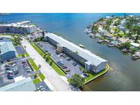 Aerial view of waterfront condo building with parking and boat slips at 1893 Shore S Dr # 206, South Pasadena, FL 33707