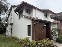 Two-story condo with brick accents and landscaping at 615 Fairmont Ave # C, Safety Harbor, FL 34695