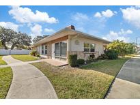 Updated one-story home with landscaped yard and walkway at 4321 Tahitian Gardens Cir # A, Holiday, FL 34691