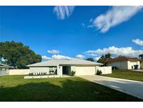 Charming single-story home featuring a well-manicured lawn and an attached two-car garage at 10234 Bedford Rd, Spring Hill, FL 34608