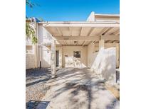 Front view of townhouse with carport and landscaping at 5227 Tennis Court Cir, Tampa, FL 33617