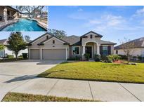 House exterior featuring a three-car garage and well-manicured lawn at 692 Challice Dr, Spring Hill, FL 34609